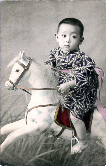 Child with hobby horse, c. 1910.