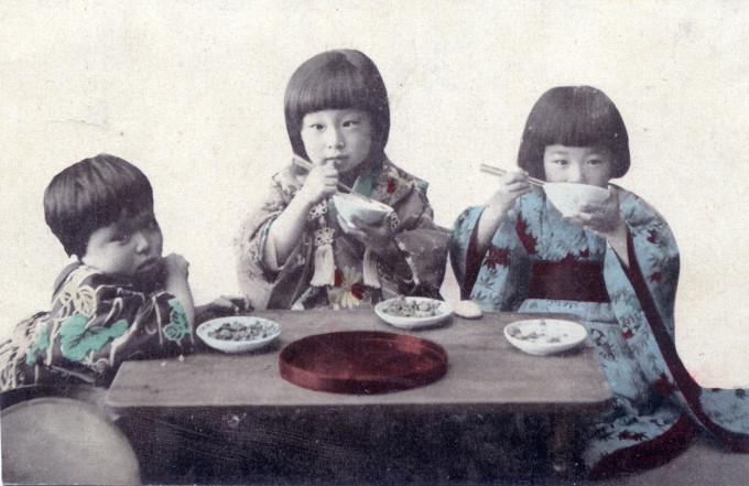 Children eating lunch, c. 1910.