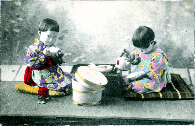 Children with bowls of rice, c. 1910.
