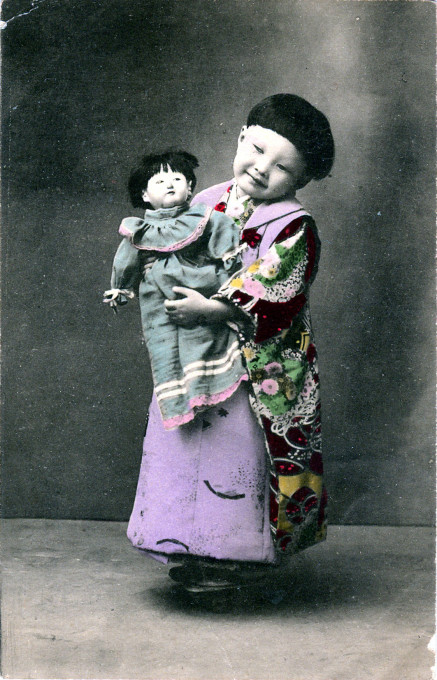 Child with doll, c. 1910.